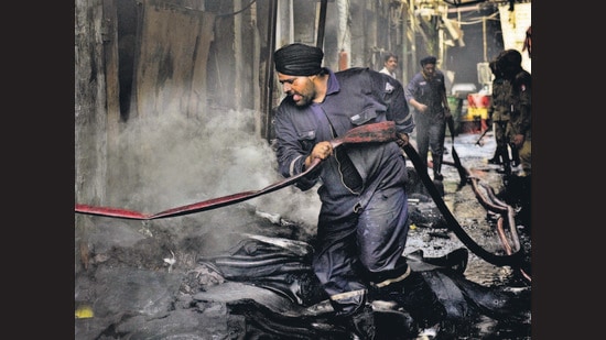 Firefighters dousing the flames at Hindustan Tyres and Tubes, RK Road, Industrial Area, in Ludhiana on Saturday. (Gurpreet Singh/HT)