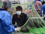 A health worker tends to a Covid-19 patient recovering at the CWG village Covid Care Centre in New Delhi, on July 4. Active cases of the coronavirus disease (Covid-19) in Delhi fell below 1000 to 992 on July 4.(Kamal Kishore / PTI)