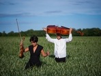 Cellist Jacob Shaw (R) and violinist Roberta Verna are pictured on a corn field on June 15 in Stevns, Denmark. Unable to perform during the pandemic, Shaw turned to an unusual audience, an experience so rewarding that he is continuing even after concert halls have reopened.(Jonathan Nackstrand / AFP)