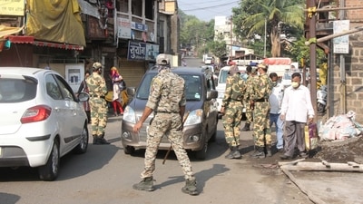Police personnel check motorists to restrict unnecessary vehicular movement amid strict restrictions imposed by the state government due to rising Covid-19 cases in Satara. (Hindustan Times)