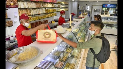 People purchasing sweets from a shop in Ludhiana on Sunday. (Harsimar Pal Singh/HT) People purchasing sweets from a shop in Ludhiana on Sunday. (Harsimar Pal Singh/HT)