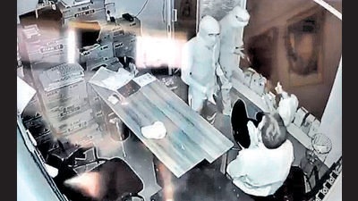 A CCTV grab of the robbers pointing guns at two employees at Bhim petrol pump in Kharar in the wee hours of Sunday. (HT Photo)