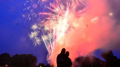 Carolina Carrasco and NYC Torunski, from Brattleboro, Vt., watch fireworks during the Hinsdale, N.H., Fourth of the July firework show on Saturday, July 3, 2021. (Kristopher Radder/The Brattleboro Reformer via AP) Carolina Carrasco and NYC Torunski, from Brattleboro, Vt., watch fireworks during the Hinsdale, N.H., Fourth of the July firework show on Saturday, July 3, 2021. (Kristopher Radder/The Brattleboro Reformer via AP)