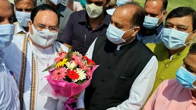 Himachal CM Jai Ram Thakur (in black) welcomes BJP national president JP Nadda on his arrival at Bilaspur on Sunday.
