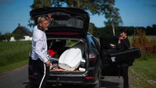 Cellist Jacob Shaw (L) and violinist Roberta Verna load their instruments in a car ahead of their classical music concert for a herd of cows on June 15 in Stevns, Denmark. The British musician, who is also a professor at the Marshall Academy in Barcelona, has set up a cello school in the rural countryside in Stevns, an hour south of Copenhagen, performing throughout the region.(Jonathan Nackstrand / AFP)
