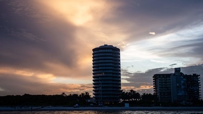 The partially collapsed Champlain South tower (R) is seen in Surfside, Florida, north of Miami Beach, on July 4, 2021. (AFP)