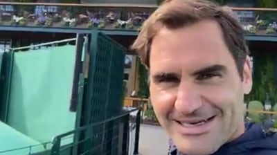 Roger Federer walking around the Wimbledon club and grass courts during Middle Sunday and sends out a message for his fan. (Screengrab)