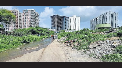 The current approach road to Anandvan Phase II is narrow and littered with construction debris, causing inconvenience to residents. (HT PHOTO) The current approach road to Anandvan Phase II is narrow and littered with construction debris, causing inconvenience to residents. (HT PHOTO)