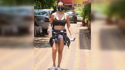 Malaika paired the sports bra with a pair of white shorts that had black straps. She rounded off her gym look by tying a grey and black workout jacket around her waist. (Varinder Chawla) Malaika paired the sports bra with a pair of white shorts that had black straps. She rounded off her gym look by tying a grey and black workout jacket around her waist. (Varinder Chawla)