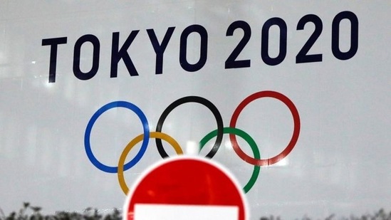 The logo of Tokyo 2020 Olympic Games, that have been postponed to 2021, is seen through a traffic sign at Tokyo Metropolitan Government Office building in Tokyo, Japan. (File photo)