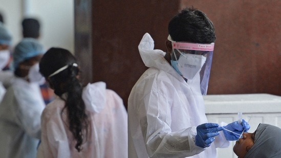 Passengers arriving on international flights get their Covid-19 screening done at the Anna International airport in Chennai. (AFP file photo)