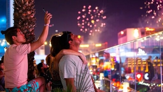 People cannot stop looking at the sky as fireworks explode over the Las Vegas Strip on July 4.(Chase Stevens/Las Vegas Review-Journal via AP)