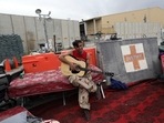 An Afghan soldier plays a guitar that was left behind after the American military departed Bagram air base, in Parwan province north of Kabul, Afghanistan on July 5. American troops handed the base over to Afghan security forces to bring an effective end to the longest war in US history, following an agreement with the insurgent Islamist Taliban last year.(Rahmat Gul / AP)