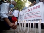Members of The Bombay Catholic Sabha hold a memorial mass outside St. Peter's Church in Bandra in protest holding banners and lighting candles for the Indian rights activist and Jesuit priest Father Stan Swamy.