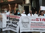People hold banners and shout slogans during a prayer meeting for Father Stan Swamy outside a church in Mumbai, India, Tuesday, July 6, 2021.(AP) People hold banners and shout slogans during a prayer meeting for Father Stan Swamy outside a church in Mumbai, India, Tuesday, July 6, 2021.(AP)