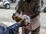 A sales assistant hands produce to a customer at a grocery store, known as a kirana, in Bengaluru, India, on Monday, Jun. 21, 2021.(Bloomberg) A sales assistant hands produce to a customer at a grocery store, known as a kirana, in Bengaluru, India, on Monday, Jun. 21, 2021.(Bloomberg)