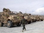 An Afghan army soldier walks past Mine Resistant Ambush Protected vehicles, MRAP, that were left after the American military left Bagram air base, in Parwan province north of Kabul, Afghanistan, Monday, July 5, 2021. An Afghan army soldier walks past Mine Resistant Ambush Protected vehicles, MRAP, that were left after the American military left Bagram air base, in Parwan province north of Kabul, Afghanistan, Monday, July 5, 2021.