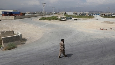 A member of the Afghan security forces walks in the sprawling Bagram air base after the American military departed, in Parwan province on July 5. “They (Americans) are completely out now and everything is under our control, including watchtowers, air traffic and the hospital,” a senior Afghan government official told Reuters. (Rahmat Gul / AP) A member of the Afghan security forces walks in the sprawling Bagram air base after the American military departed, in Parwan province on July 5. “They (Americans) are completely out now and everything is under our control, including watchtowers, air traffic and the hospital,” a senior Afghan government official told Reuters. (Rahmat Gul / AP)