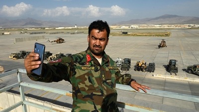 An Afghan National Army (ANA) soldier take a selfie with his mobile phone inside the Bagram air base after all US and NATO troops left, on July 5. Neighbourhoods and markets in the shadow of the base are left ruing the past and bracing for what comes next. (Wakil Kohsar / AFP) An Afghan National Army (ANA) soldier take a selfie with his mobile phone inside the Bagram air base after all US and NATO troops left, on July 5. Neighbourhoods and markets in the shadow of the base are left ruing the past and bracing for what comes next. (Wakil Kohsar / AFP)