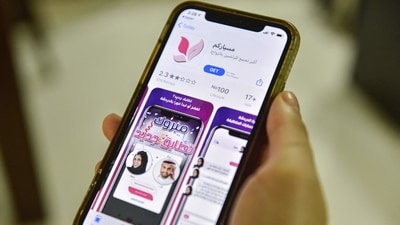 A woman holds an Apple iPhone device showing on its App Store an app for facilitating "Misyar" marriage, available in Saudi Arabia, in the capital Riyadh. (AFP)