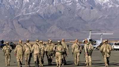 In this file photo taken on January 15, 2002, American soldiers approach the United Nations planes on the tarmac of the Bargam airbase in Bagram. (AFP)
