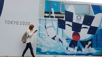 A woman walks by posters to promote the Tokyo Olympics in Tokyo, Monday, July 5, 2021. (AP) A woman walks by posters to promote the Tokyo Olympics in Tokyo, Monday, July 5, 2021. (AP)