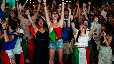Fans react as Italy's Federico Chiesa scored his side's first goal as they watch on a giant screen the Euro 2020 soccer semifinal match between Italy and Spain, in Rome, Tuesday, July 6, 2021. (AP Photo/Alessandra Tarantino) (AP) Fans react as Italy's Federico Chiesa scored his side's first goal as they watch on a giant screen the Euro 2020 soccer semifinal match between Italy and Spain, in Rome, Tuesday, July 6, 2021. (AP Photo/Alessandra Tarantino) (AP)