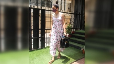 Rakul completed the floral look with tan open-toe sandals and a purple face mask to keep herself safe during the pandemic. She tied her locks in a sleek top bun and opted for minimal make-up. (Varinder Chawla) Rakul completed the floral look with tan open-toe sandals and a purple face mask to keep herself safe during the pandemic. She tied her locks in a sleek top bun and opted for minimal make-up. (Varinder Chawla)