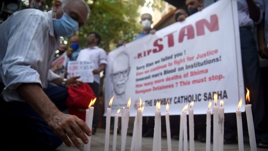 Members of The Bombay Catholic Sabha hold a memorial mass outside St. Peter's Church in Bandra in protest holding banners and lighting candles for the Indian rights activist and Jesuit priest Father Stan Swamy, who was detained for nine months under Indian anti-terrorism law without trial, died on Monday ahead on his bail hearing, in Mumbai. ( Vijay Bate/HT Photo) Members of The Bombay Catholic Sabha hold a memorial mass outside St. Peter's Church in Bandra in protest holding banners and lighting candles for the Indian rights activist and Jesuit priest Father Stan Swamy, who was detained for nine months under Indian anti-terrorism law without trial, died on Monday ahead on his bail hearing, in Mumbai. ( Vijay Bate/HT Photo)