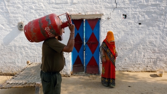 A worker delivers an LPG cylinder to a village home in Greater Noida.(Bloomberg Photo)