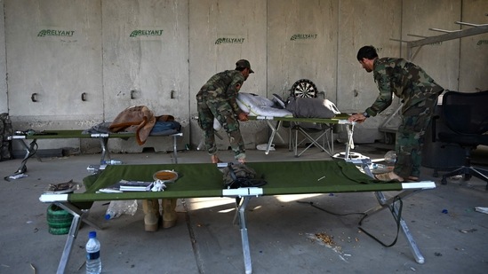 Afghan National Army (ANA) soldiers carry stretchers inside the Bagram air base after all US and NATO troops left, some 70 Kms north of Kabul on July 5. Peace talks between the Taliban and the Afghan government remain inconclusive, and many fear the country could descend into a full-blown civil war once again.(Wakil Kohsar / AFP)