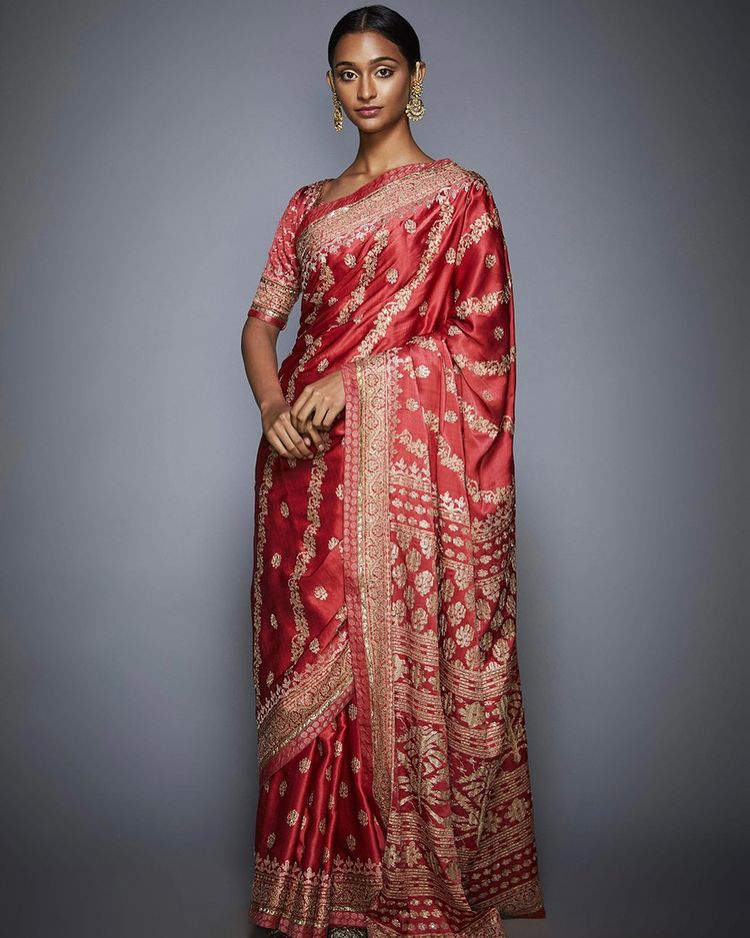 Timeless red sari with intricate aari embroidery, inspired by the heritage motifs