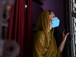 A resident looks out from her home during a door-to-door drive to register people for vaccination against Covid-19 in New Delhi on July 6. Over 25,000 people in the capital have died of Covid-19 since the outbreak of the infection in March last year, government records showed, after the state added four fatalities to the city’s toll on July 6.