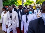 Haiti's President Jovenel Moise, centre left, holds hands with his wife Martine, as he walks with then-prime minister Joseph Jouthe, right.(AP) Haiti's President Jovenel Moise, centre left, holds hands with his wife Martine, as he walks with then-prime minister Joseph Jouthe, right.(AP)