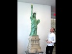 The image shows Amaury Guichon standing beside the seven-foot-long chocolate Statue of Liberty.(Instagram/@amauryguichon)