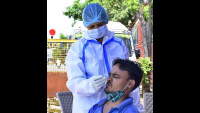Health worker collecting swab samples near civil hospital in Ludhiana. (Harsimar Pal Singh/HT)