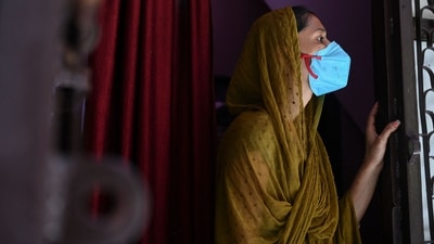 A resident looks out from her home during a door-to-door drive to register people for vaccination against Covid-19 in New Delhi on July 6. Over 25,000 people in the capital have died of Covid-19 since the outbreak of the infection in March last year, government records showed, after the state added four fatalities to the city’s toll on July 6. (Sajjad Hussain / AFP) A resident looks out from her home during a door-to-door drive to register people for vaccination against Covid-19 in New Delhi on July 6. Over 25,000 people in the capital have died of Covid-19 since the outbreak of the infection in March last year, government records showed, after the state added four fatalities to the city’s toll on July 6. (Sajjad Hussain / AFP)