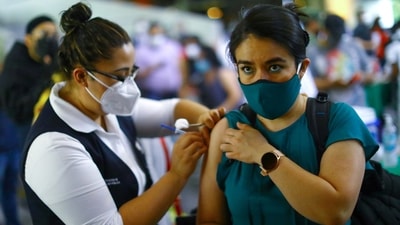 A woman receives a dose of the AstraZeneca coronavirus disease vaccine during a mass vaccination in Mexico City. (Reuters Photo)