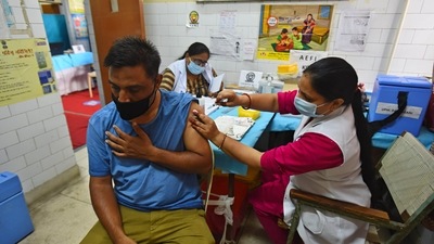 A healthcare worker administering a dose of Covid-19 vaccine to a beneficiary, at a government dispensary in New Delhi. (Raj K Raj / HT Photo)