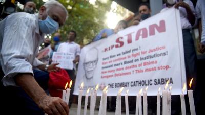 Members of The Bombay Catholic Sabha hold a memorial mass outside St. Peter's Church in Bandra on Tuesday for rights activist and Jesuit priest Father Stan Swamy, who died on Monday. (HT PHOTO)