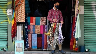 A vendor wearing a facemask as a preventive measure against the spread of the Covid-19 coronavirus, opens his shop at a market in New Delhi on July 5. Experts HT spoke to have said that a fifth wave in Delhi is unlikely for “at least six months”. (Sajjad Hussain / AFP) A vendor wearing a facemask as a preventive measure against the spread of the Covid-19 coronavirus, opens his shop at a market in New Delhi on July 5. Experts HT spoke to have said that a fifth wave in Delhi is unlikely for “at least six months”. (Sajjad Hussain / AFP)