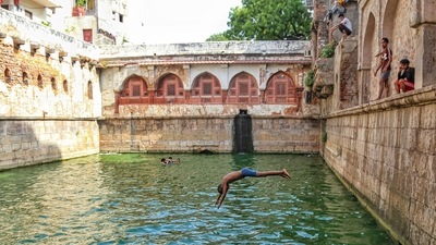 A boy jumps into the water of a 'baoli' during a hot summer day at Dargah Hazrat Nizamuddin in New Delhi, Wednesday, July 7, 2021. (PTI) A boy jumps into the water of a 'baoli' during a hot summer day at Dargah Hazrat Nizamuddin in New Delhi, Wednesday, July 7, 2021. (PTI)