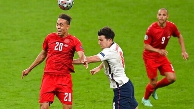Denmark's Yussuf Poulsen, left, and England's Harry Maguire compete to head the ball during the Euro 2020 soccer championship semifinal between England and Denmark at Wembley stadium in London, Wednesday, July 7, 2021. (Justin Tallis/Pool Photo via AP) (AP) Denmark's Yussuf Poulsen, left, and England's Harry Maguire compete to head the ball during the Euro 2020 soccer championship semifinal between England and Denmark at Wembley stadium in London, Wednesday, July 7, 2021. (Justin Tallis/Pool Photo via AP) (AP)