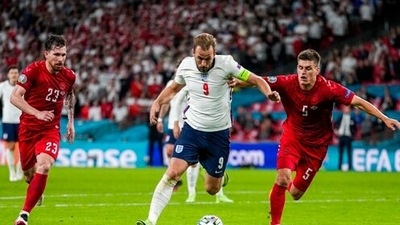 England's Harry Kane, center, duels for the ball with Denmark's Joakim Maehle, right, during the Euro 2020 soccer championship semifinal match between England and Denmark at Wembley stadium in London, Wednesday, July 7, 2021. (AP Photo/Frank Augstein, Pool) (AP) England's Harry Kane, center, duels for the ball with Denmark's Joakim Maehle, right, during the Euro 2020 soccer championship semifinal match between England and Denmark at Wembley stadium in London, Wednesday, July 7, 2021. (AP Photo/Frank Augstein, Pool) (AP)