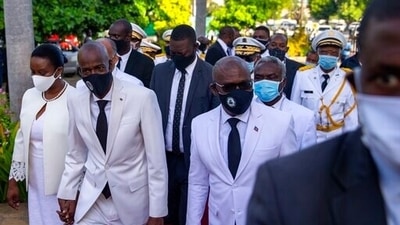 Haiti's President Jovenel Moise, centre left, holds hands with his wife Martine, as he walks with then-prime minister Joseph Jouthe, right. (AP) Haiti's President Jovenel Moise, centre left, holds hands with his wife Martine, as he walks with then-prime minister Joseph Jouthe, right. (AP)