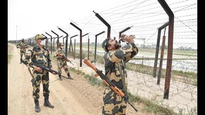 Border Security Force personnel along the barbed-wire fence along India-Pakistan border in Amritsar district.