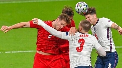 England's Luke Shaw and John Stones, right, compete to head the ball with Denmark's Joachim Andersen, left, during the Euro 2020 soccer championship semifinal between England and Denmark at Wembley stadium in London, Wednesday, July 7, 2021. (Justin Tallis/Pool Photo via AP) (AP) England's Luke Shaw and John Stones, right, compete to head the ball with Denmark's Joachim Andersen, left, during the Euro 2020 soccer championship semifinal between England and Denmark at Wembley stadium in London, Wednesday, July 7, 2021. (Justin Tallis/Pool Photo via AP) (AP)
