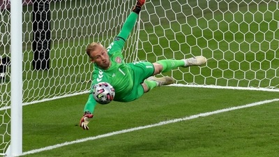 Denmark's goalkeeper Kasper Schmeichel dives to save a shot from England's Harry Maguire during the Euro 2020 soccer championship semifinal match between England and Denmark at Wembley stadium in London, Wednesday, July 7, 2021. (Catherine Ivill/Pool Photo via AP) (AP) Denmark's goalkeeper Kasper Schmeichel dives to save a shot from England's Harry Maguire during the Euro 2020 soccer championship semifinal match between England and Denmark at Wembley stadium in London, Wednesday, July 7, 2021. (Catherine Ivill/Pool Photo via AP) (AP)
