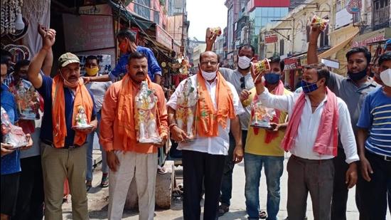 Traders beating drums in Haridwar to oppose proposed ferrying of Ganga Jal in tankers for Kanwariyas. They also demanded the opening of Kanwar yatra. (HT PHOTO.)
