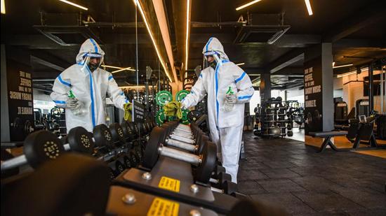 A worker in PPE coveralls chemically disinfects equipment in a gym ahead of its reopening under unlock guidelines in New Delhi. (Representational image/HT Archive) A worker in PPE coveralls chemically disinfects equipment in a gym ahead of its reopening under unlock guidelines in New Delhi. (Representational image/HT Archive)